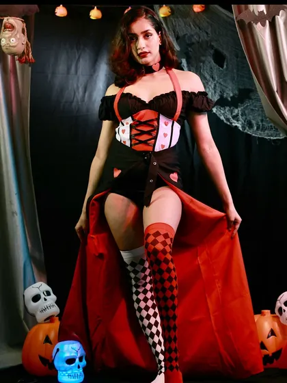 This full-length shot of the Queen of Hearts costume shows off the dramatic, flowing red cape that adds an extra layer of royal menace to the look.