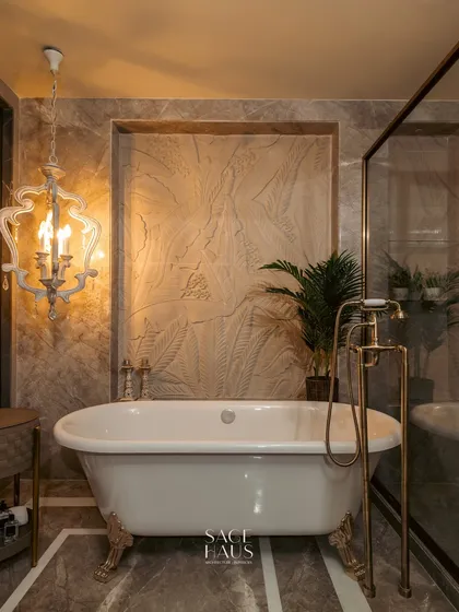 I believe a master bathroom should be a private escape. In this design, a classic freestanding bathtub is set against a backdrop of textured stone and rich marble, with elegant brass fixtures and a statement chandelier to create a spa-like experience at home.