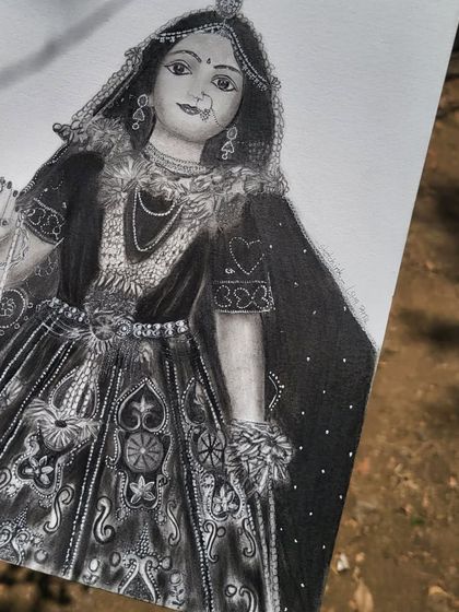 An angled view of my Radha Rani portrait, showing the texture of the paper and the depth of the graphite shading. This piece took a lot of patience, but I'm so happy with how her divine grace came through.