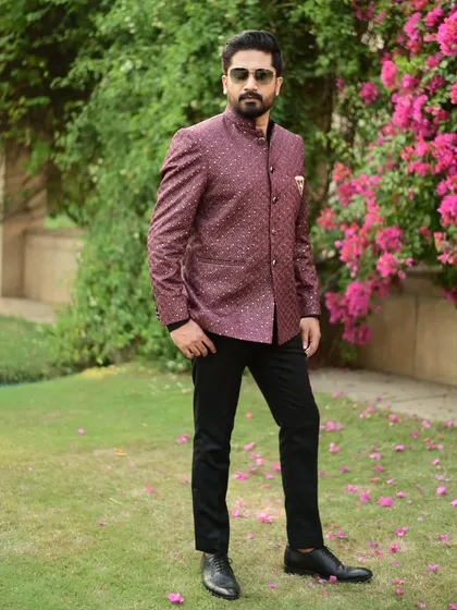 A client looking sharp in a maroon Jodhpuri jacket. This is a great choice for adding a touch of color to a formal look.