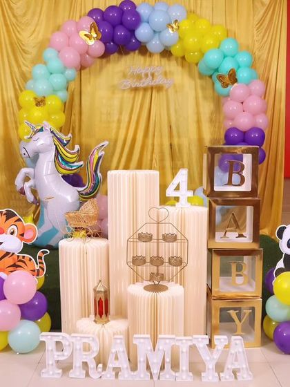 A magical 'Frozen 2' themed birthday party, transforming the venue into an enchanted forest with earthy tones, character cutouts, and shimmering backdrops.