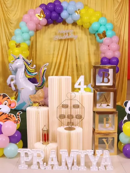 A colorful and cheerful animal and unicorn themed party setup, perfect for a fourth birthday celebration.
