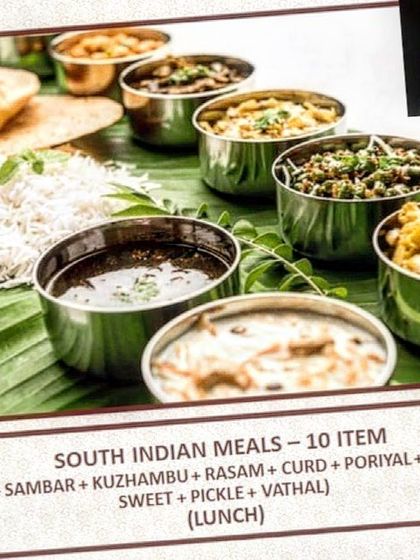 This is an example of our 10-item South Indian lunch meal. It includes a balanced selection of dishes like rice, sambar, kuzhambu, rasam, poriyal, kootu, and a sweet, providing a complete and satisfying traditional meal.