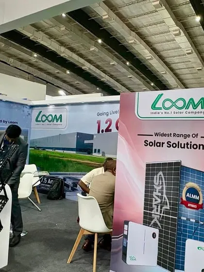 Visitors exploring the product displays at my booth. I make sure to have a wide range of our solar solutions, from SHARK panels to inverters, available for a hands-on look.