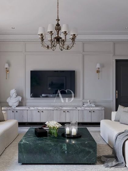 The television is seamlessly integrated into the classical design by mounting it on a paneled wall above a marble-topped console. This approach ensures modern technology does not detract from the room's timeless elegance.