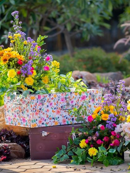 A charming decor detail: custom-printed floral trunks used as pedestals for flower arrangements.