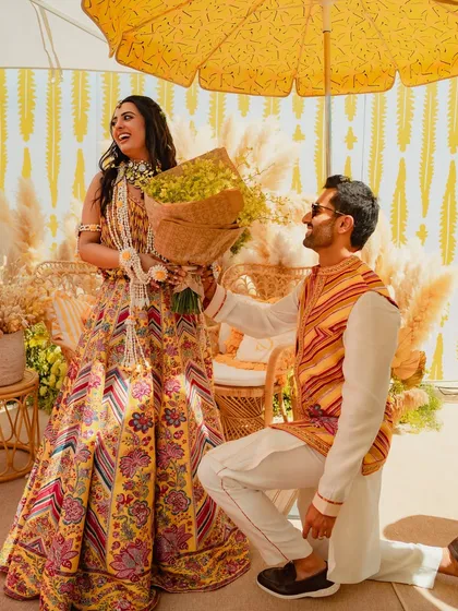 A sweet, candid moment of the couple at their Mehendi, perfectly framed by the boho-chic decor I designed for their special day.
