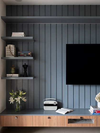 A duplicate of image 82, showing the grey paneled TV unit.