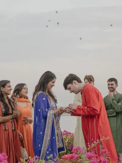 James looks for his name in Pearl’s henna on a bridge overlooking the Udaipur lake. This quiet, romantic moment captures the beauty of their destination and their connection.