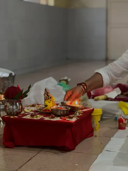 Lighting the lamp during a puja. The flame symbolizes the light of knowledge dispelling the darkness of ignorance.