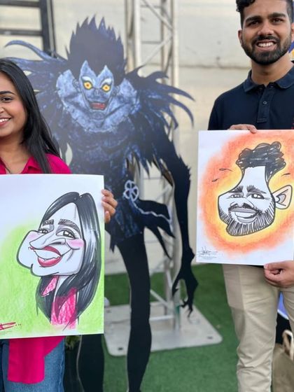 A couple posing with their caricatures in front of a character from the anime Death Note. A very cool and thematic event.
