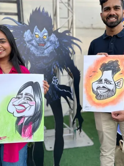 A couple with their colorful caricatures in front of a Death Note character cutout at the Anime Fan Fest. It's always fun to draw at themed events.