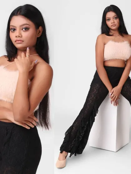 A model wearing a faux fur crop top and lace pants. This look is suitable for a trendy, youth-focused fashion brand's portfolio or lookbook.
