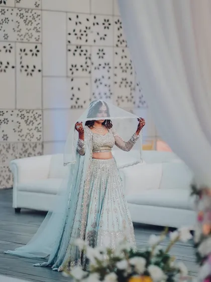 A shy glance from the bride under her veil before her big reveal. A moment of quiet anticipation and beauty.