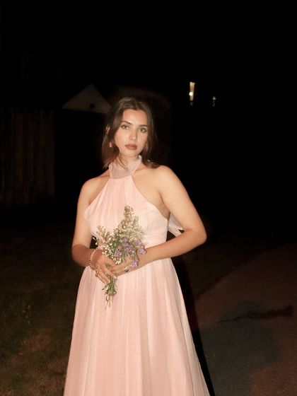 A direct-to-camera portrait in the pink dress, creating an ethereal and romantic look.