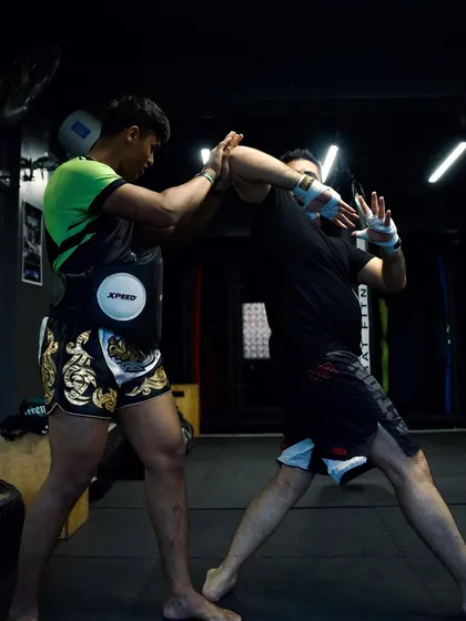 Two fighters practice hand-trapping and blocking drills, essential for close-range defense.