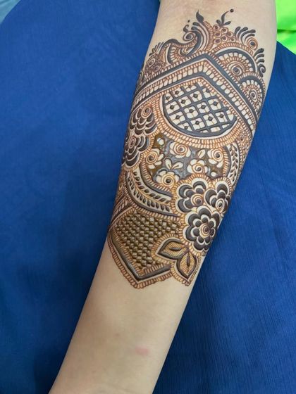 A single arm design with a large heart-shaped motif, filled with intricate patterns.