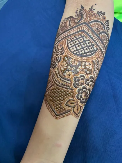 A close-up of the arm band, featuring a heart-shaped pattern filled with delicate netting.