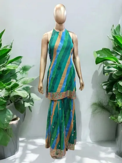 This stunning halter sharara set is a perfect blend of style and sophistication. The contemporary halter neckline beautifully accentuates the shoulders, while the flowing sharara pants create a flattering, modern silhouette.