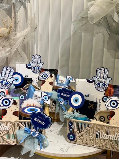 An evil-eye themed Rakhi collection. These hampers are perfect for sending good vibes and protection to your siblings, featuring personalized macrame baskets.