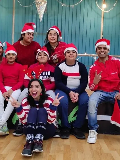 The whole group gathered for a picture during our Christmas party. You can see kids and instructors of all ages sharing the holiday spirit.