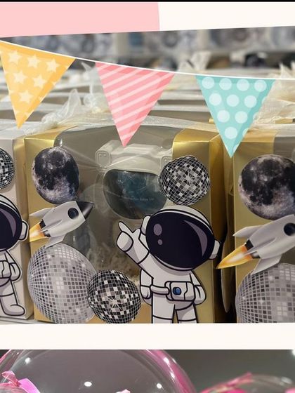 Our astronaut return gifts displayed with a cute party banner. We love helping you create a cohesive theme for your celebrations.
