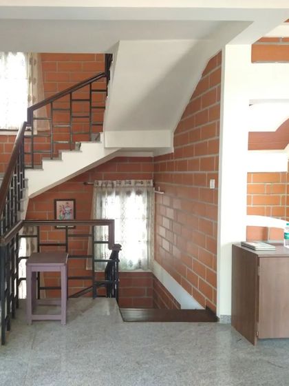 A staircase area with exposed brick walls and arched details, showcasing simple, effective design.