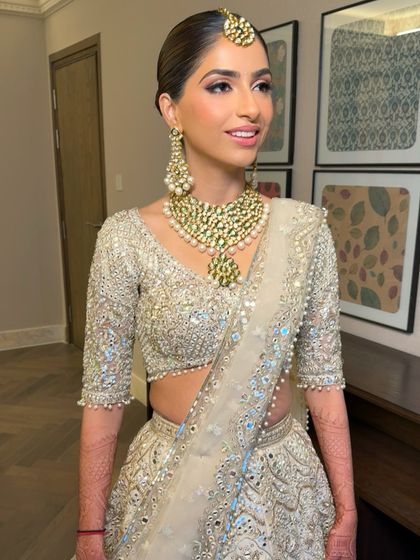 A close-up of the bride's minimal and glowy makeup. The look is clean and fresh, with a simple hairstyle that puts all the focus on her radiant complexion and beautiful smile.
