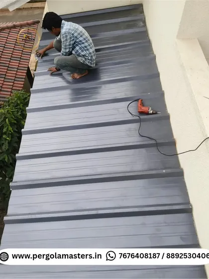 Our installer works on top of a puff sheet roof, securing the panels. This image captures the hands-on effort and attention to detail required for a professional, leak-proof installation.
