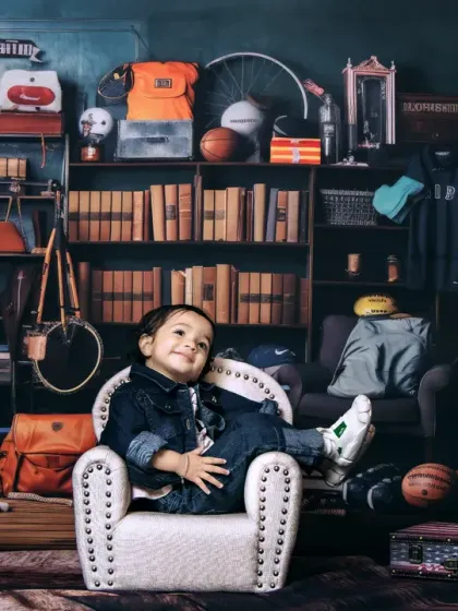 A cool and confident toddler relaxing in an armchair in our "playroom" setup.