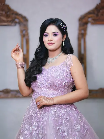 A close-up of the lilac gown, showing the delicate beading on the bodice and the soft, romantic makeup.