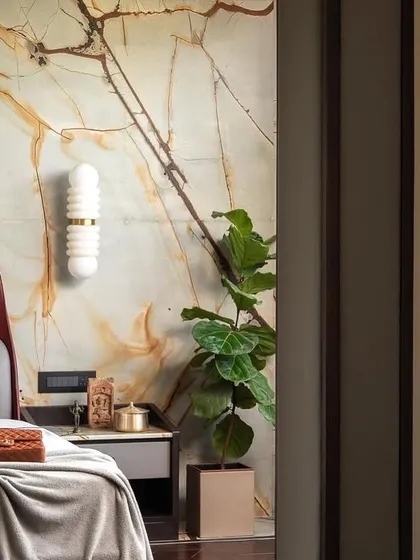Another angle of the minimalist master suite, showing the interplay of light and shadow. The elegant lighting fixtures and natural greenery create a tranquil and comfortable atmosphere.