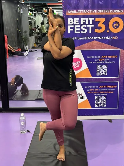 A member holds a steady Eagle Pose, showing the core strength and balance that our yoga classes help to build.