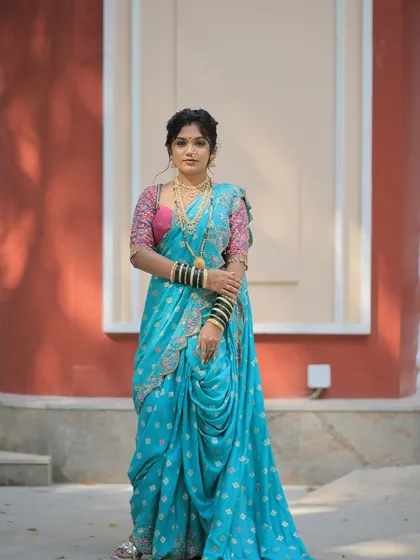 Another full-length pose of the Gudi Padwa look. The combination of the bright turquoise saree and the embroidered pink blouse creates a stunning contrast.