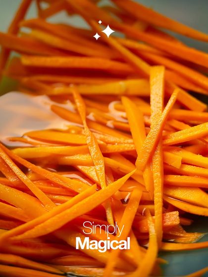 Finely julienned carrots, vibrant and ready to be pickled. The natural sweetness and crunch of the carrots are simply magical.
