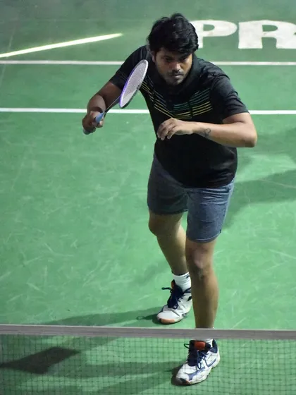 A player ready at the net, anticipating the opponent's move. This readiness is a key part of our match-play training.