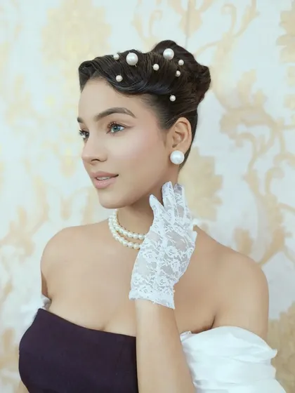 Another portrait from the vintage series. The sculpted updo with pearl details provides a timeless elegance, perfectly capturing the sophisticated spirit of a bygone era for this themed editorial.