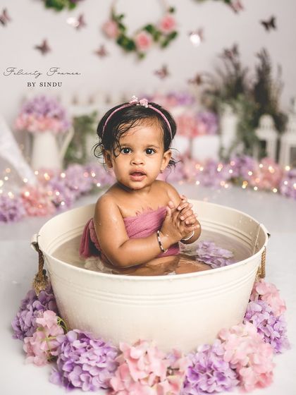 Splish, splash, it's a birthday bath! This little one is having so much fun in her floral-themed tub session after her cake smash.