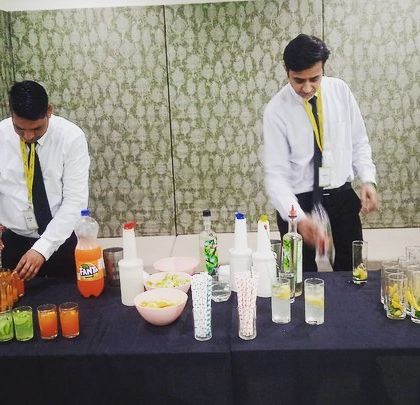Two of our bartenders working together to efficiently serve a large number of guests.