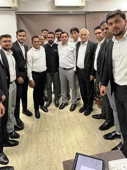 A candid moment from the app launch event. The app provides easy access to information like bail rosters, VC links, and a library of bare acts.