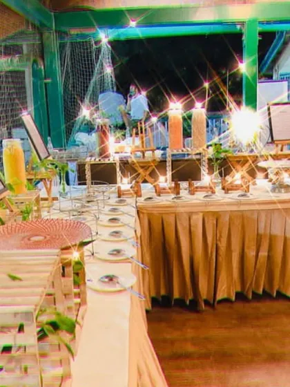 Simplicity at its best. A clean and rustic buffet setup for an outdoor event, sparkling with fairy lights.