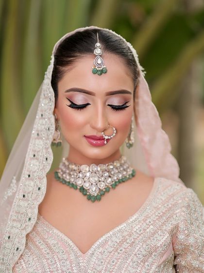A dreamy pastel bridal look that is sure to turn heads. The soft pink and silver eye makeup with a sharp wing is modern, yet timeless.