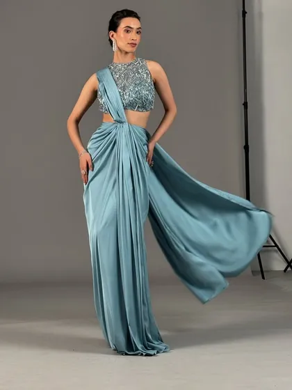 A full-length shot of the soft glam look for Kalki Fashion. The elegant updo and clean makeup create a sophisticated silhouette, perfect for this modern, pre-draped saree.