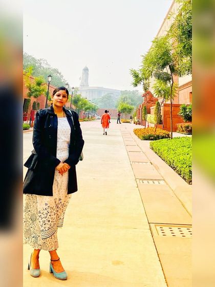 A formal yet stylish look for a visit to the Indian Parliament. I layered a classic black blazer over a white printed ethnic dress, creating a powerful and respectful ensemble for a significant location.