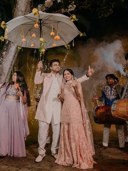The couple's festive entry to their Mehendi ceremony, accompanied by dhol players and surrounded by friends and family. The atmosphere was electric with joy and anticipation.