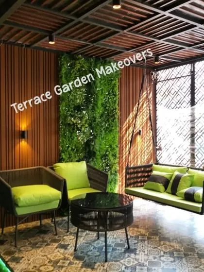 I designed this covered patio to be a perfect escape. It features comfortable seating, a relaxing swing, and lush artificial green walls, all under a stylish pergola, creating a cozy and elegant outdoor living room.