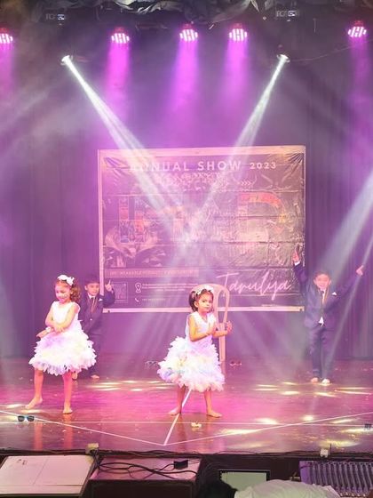 Our little stars take the stage in beautiful pastel dresses for a magical performance.