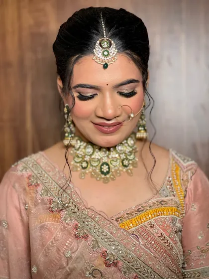 A detailed makeup shot, focusing on the soft smokey eye and the perfectly matched lip color.