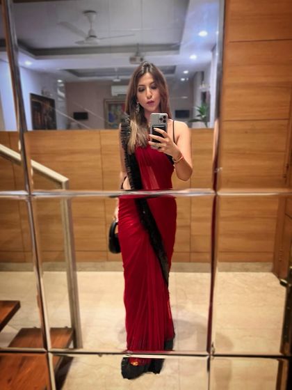 Another saree look, this time a modern red saree with a ruffled black border. Perfect for an evening event.