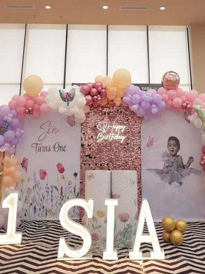 A frontal view of Sia's birthday stage, highlighting the marquee letters, light-up number '1', and the custom photo backdrop.